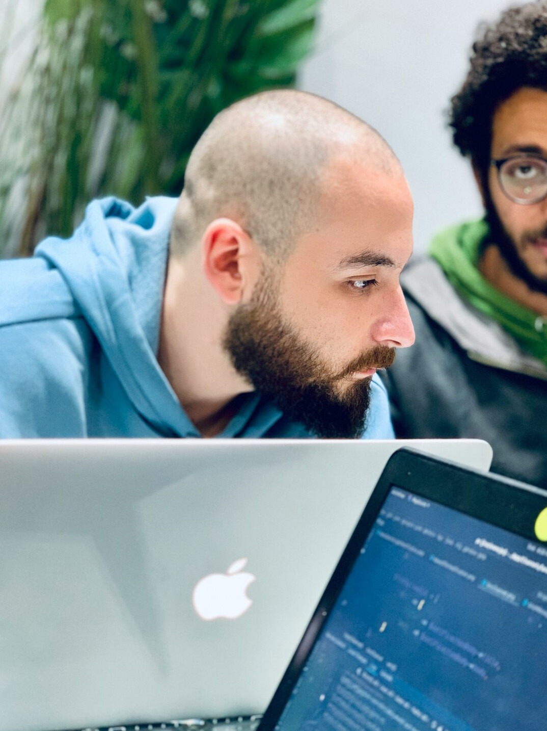 programmer coding on laptop