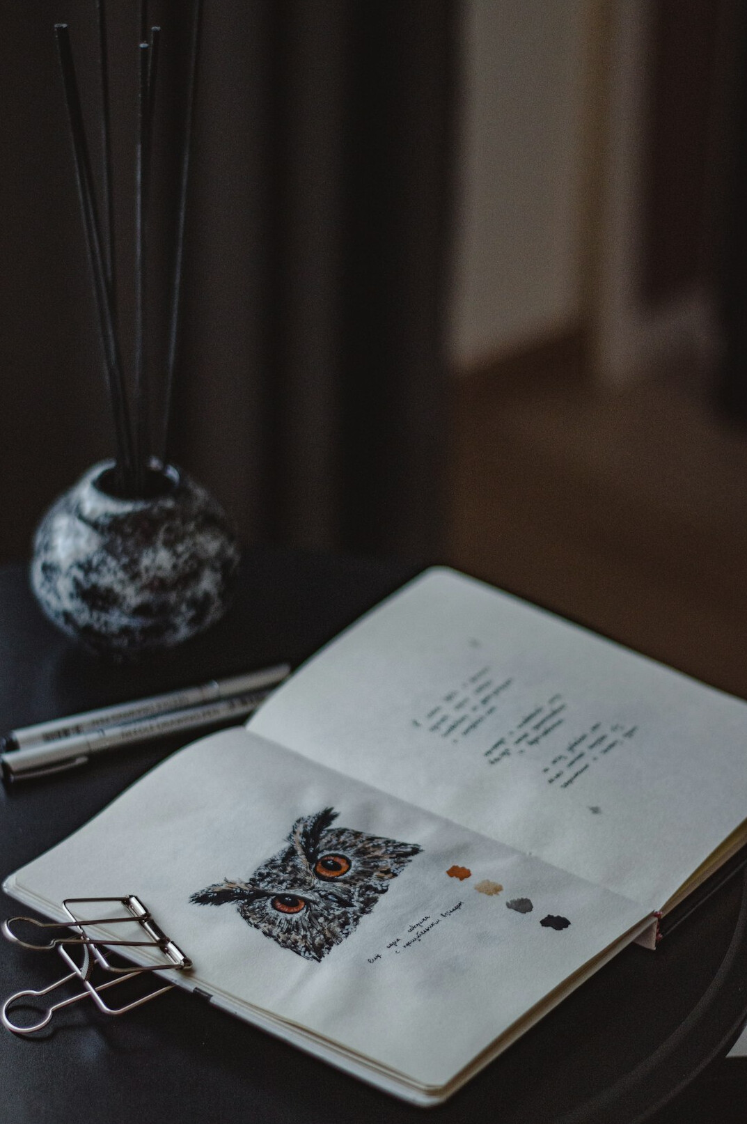 Notebook with handwritten diagrams next to a laptop