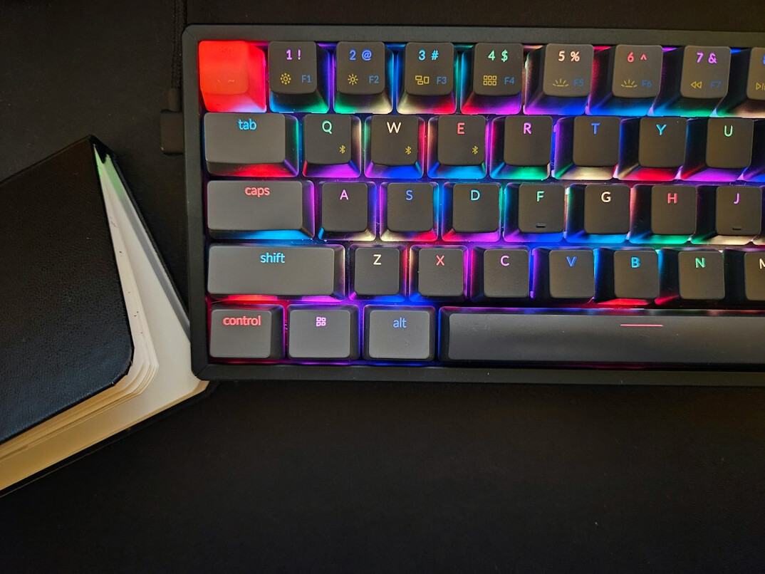 Stack of books next to a mechanical keyboard