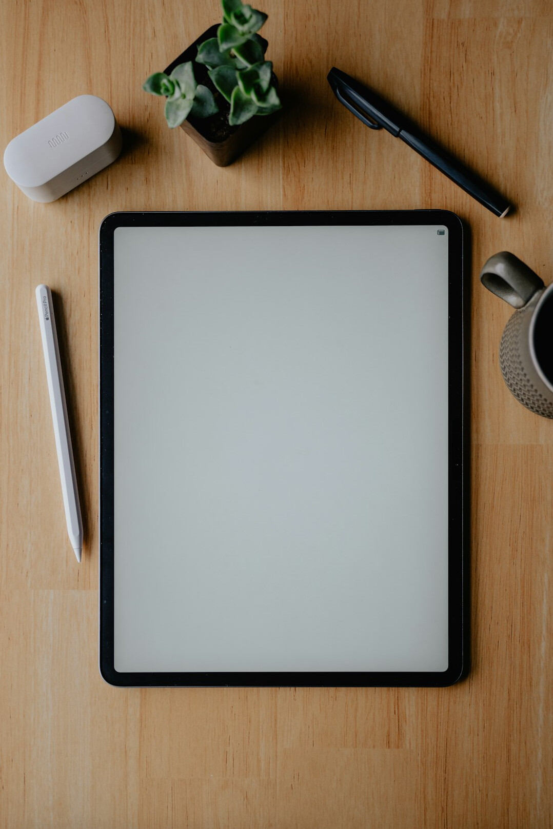 Overhead view of a desk with a tablet showing a flowchart